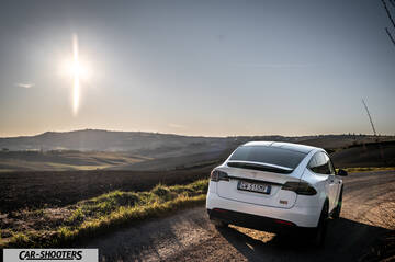 Tesla Model X – rear three-quarter, white on a country road