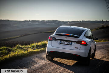 Tesla Model X – rear three-quarter, white on a country road