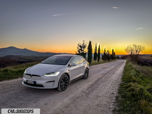 Tesla Model X – front three-quarter, white on a country road