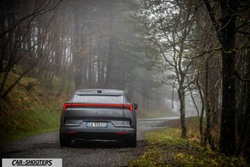 Polestar 4 – rear view, dark grey on a forest road