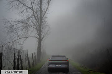 Polestar 4 – rear view, grey on a foggy country road