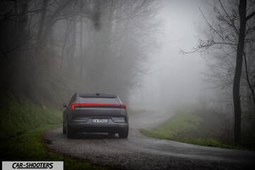 Polestar 4 – rear view, dark grey on a foggy country road