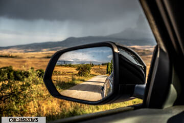 Ford Capri – detail, side mirror reflection of country road