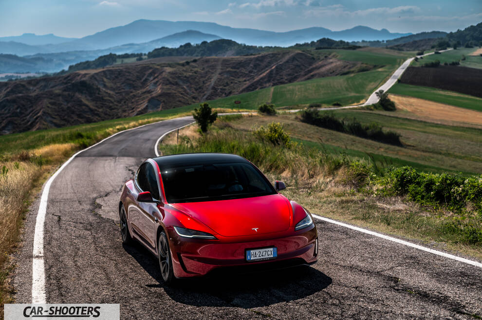 Tesla Model 3 Performance – front three-quarter, red on a country road