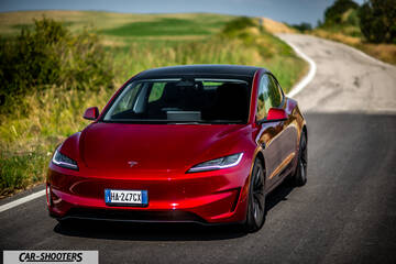 Tesla Model 3 Performance – front three-quarter, red metallic on a country road