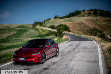 Tesla Model 3 Performance – front three-quarter, dark red on a country road