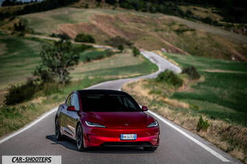 Tesla Model 3 Performance – front three-quarter, red on a country road