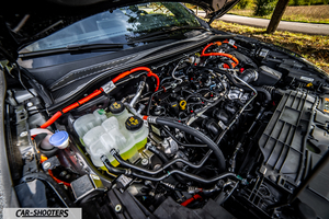 Ford Kuga 2025 – engine bay, with bright orange high voltage cables